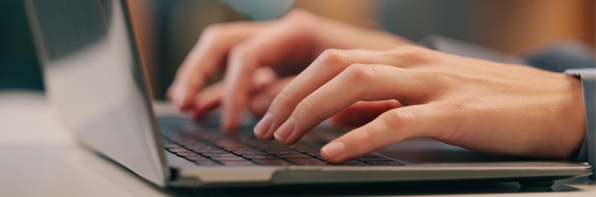 Adult typing on computer