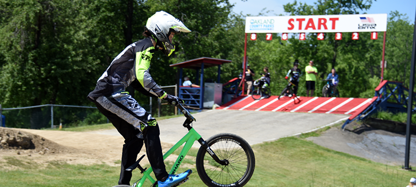 a young child pops a wheelie on the waterford bmx track